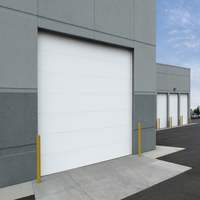 A spacious warehouse with two large entry doors