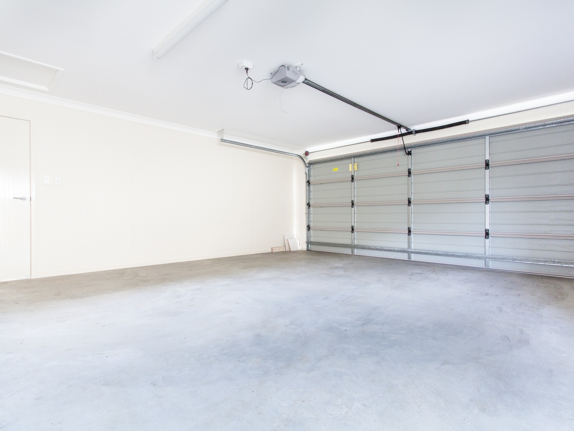 Empty garage featuring a concrete floor and an overhead garage door