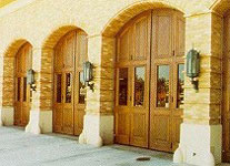 A row of wooden doors lined up in front of a building, showcasing their natural texture and design